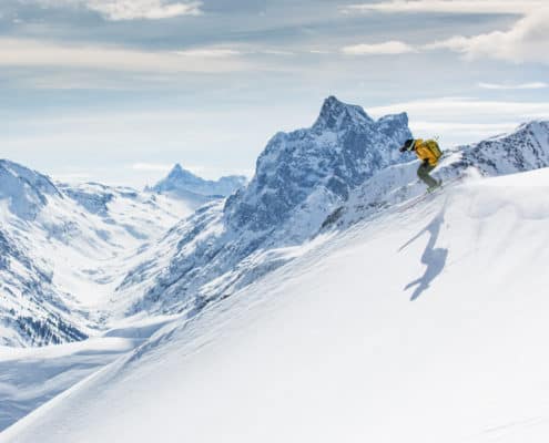 Off-piste skier in the backcountry in the mountains