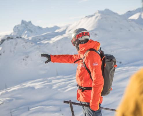Ski guide leading a skier through fresh powder snow in St. Anton am Arlberg and Lech Zürs